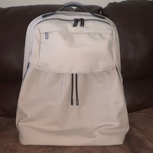 Away Travel Backpack with drawstring front pouch.